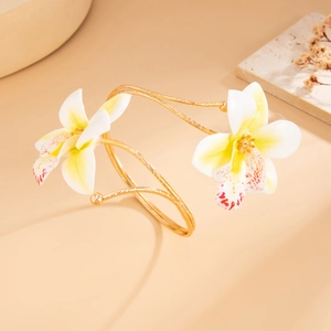 Detailed close-up of an orchid open bangle featuring gradient petals and gold metal finish