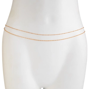 Detail of gold double-layered waist chain featuring metal beads on a slender body chain