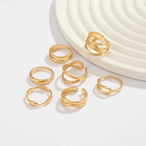Detailed view of 7-piece set of polished gold irregular geometric and wavy open rings