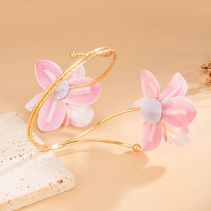 Close-up of pink fabric floral arm cuff with thin gold-tone metal wrap design