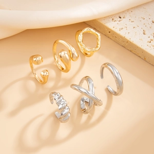 Detailed set of 6 gold and silver minimalist geometric rings on silk fabric and stone