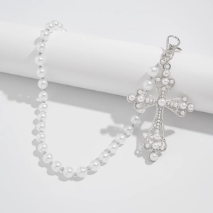 Detail view of pearl waist chain with silver hollow cross pendant and lobster clasp