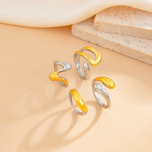 Detail of liquid metal texture and irregular lava design on gold and silver rings