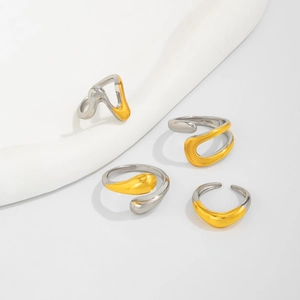 Macro view of fluid irregular water drop rings with two-tone gold and silver finish