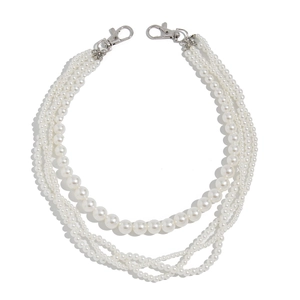 Detail of four-layer faux pearl chains with silver lobster clasps for jeans or bags