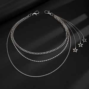 Detailed close-up of punk multi-layer silver metal waist chain with hollow star pendants