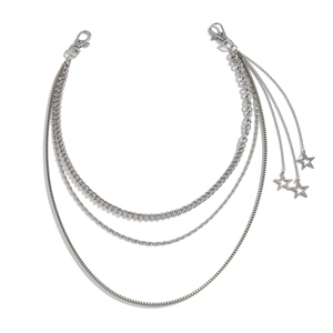 Detail of silver multi-layer punk chain with star charms and lobster clasps on white base