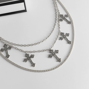 Detail of punk silver multi-layer waist chain featuring five hanging gothic cross pendants