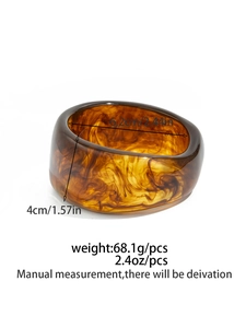 Detail view of wide amber resin bangle showing marbled texture and dimensions