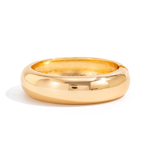 Detailed view of polished gold arched bangle showing the smooth finish and inner texture