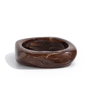 Macro shot of stylish tortoiseshell acrylic bracelet with textured marble pattern