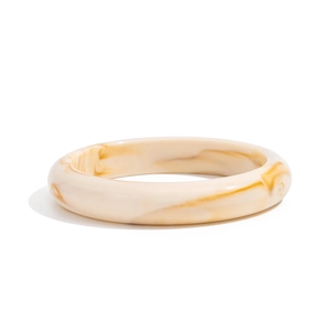 Detail view of glossy resin bangle featuring amber and ivory marble texture patterns