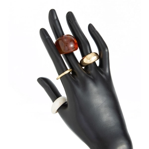 Selection of vintage resin and gold-plated metal rings displayed on a black hand model