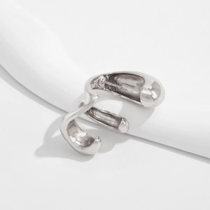 Macro detail of silver liquid metal ring with an irregular organic flow and high polish