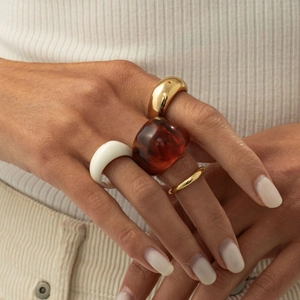 Set of minimalist metal and resin rings including teardrop and amber tortoise shell styles
