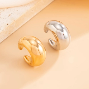 Polished gold and silver C-shaped wide ear cuffs with a minimalist geometric design