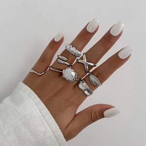 Detailed view of silver ring set with liquid metal texture and pearl accent