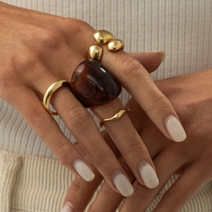 Chunky amber resin ring and polished gold stacked rings set on hand for women