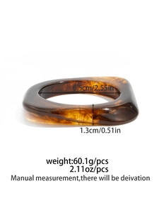 Detail view of amber resin bangle showing dimensions 6.5cm inner diameter and 60.1g weight