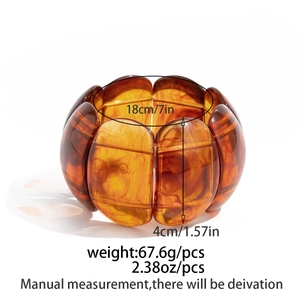 Detail view of 4cm wide amber acrylic resin bangle showing inner diameter and texture