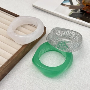 Chunky irregular acrylic bangles set in marble white, silver foil, and emerald green