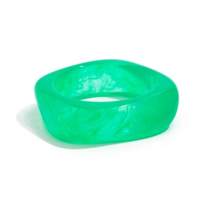 Macro view of transparent green acrylic resin bangle with marbled ink texture detail