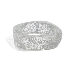 Detailed macro view of a wide transparent resin bangle with shiny silver foil flakes