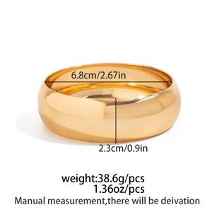 Detailed view of wide gold metal cuff bracelet with product dimensions and weight specs