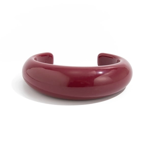 Detailed close-up of glossy wine red irregular resin open cuff bracelet with mirror finish