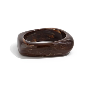 Detailed view of irregular tortoiseshell resin bangle with deep brown marble pattern