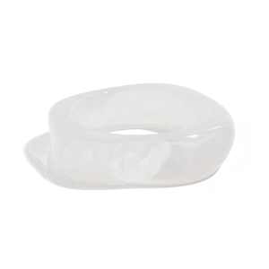 Macro detail of irregular translucent white acrylic resin ring with smooth organic texture