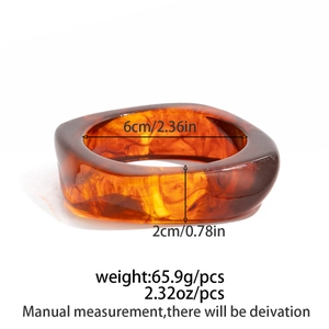 Detailed view of amber resin bangle showing 6cm inner diameter and 2cm width specs