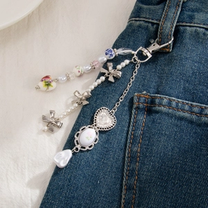 Three-layer keychain with ceramic beads, pearl bow and heart pendant on denim
