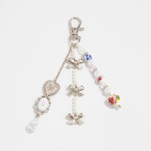 Blue and white ceramic flower keychain with pearls and bow charms on silver chains