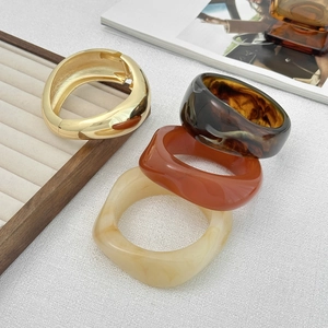 Close-up of irregular resin acrylic bangles with gold foil and tortoiseshell patterns