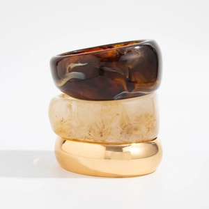 Three-piece stackable bracelet set with resin tortoise shell and gold metal finish