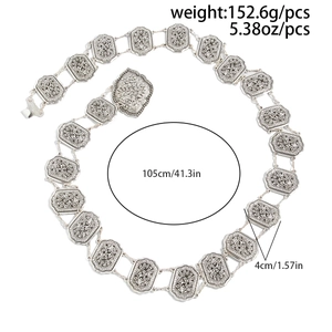Detail of vintage silver waist chain with embossed floral patterns and bohemian style