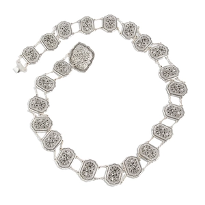 Detailed view of silver waist chain featuring etched octagonal floral metal plates