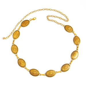 Close-up of golden boho waist chain featuring embossed oval metal plates and lobster clasp
