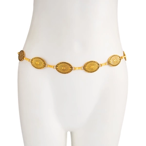 Detailed macro view of Bohemian golden metal waist chain with vintage sunburst oval medallions