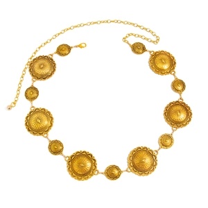 Detail of vintage gold metal waist chain with embossed sunburst pattern and lobster clasp