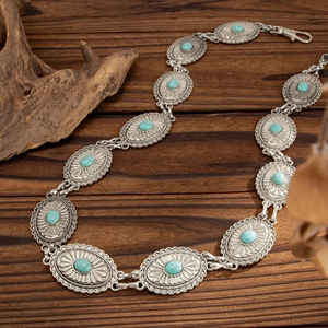 Detailed view of bohemian turquoise waist chain with vintage silver metal oval patterns