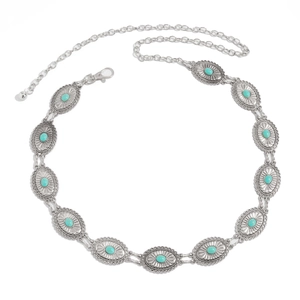 Detail of silver bohemian waist chain with oval green turquoise stones and ethnic patterns