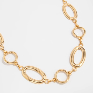 Close-up of polished gold punk style chain with irregular oval and round links