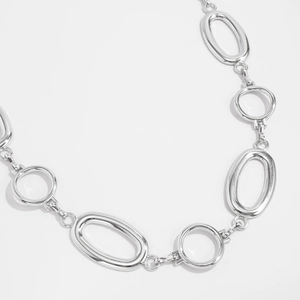 Macro shot of silver hollow oval links and polished metal chain belt connectors