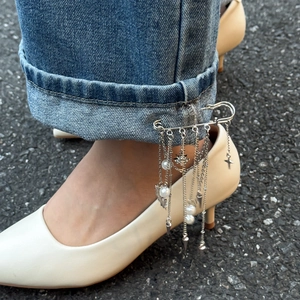Silver safety pin brooch with long tassel chains, pearls, and star charms for pants