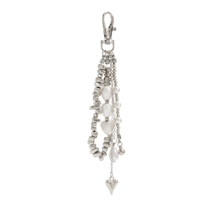 Macro view of silver beads, pearls, and heart pendant on a multi-strand keychain
