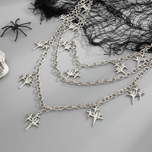 Detail of silver multi-layered star pendants chain with punk gothic aesthetic elements