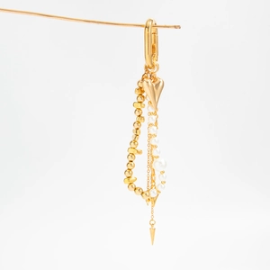 Detailed view of multilayer chain with golden heart pendant and white pearls