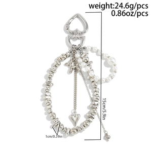 Detail of multi-layer silver bag chain with pearls, heart charm, and balloon dog pendant